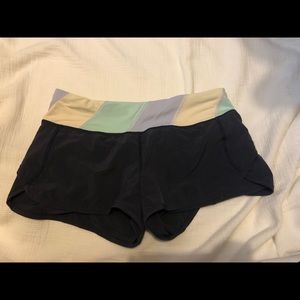Plum colored lululemon run speed shorts.